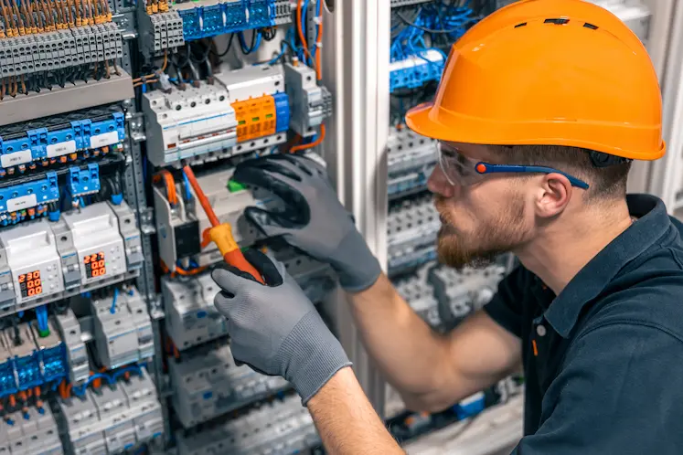 Local electrician inspecting an electrical box at an East of England property