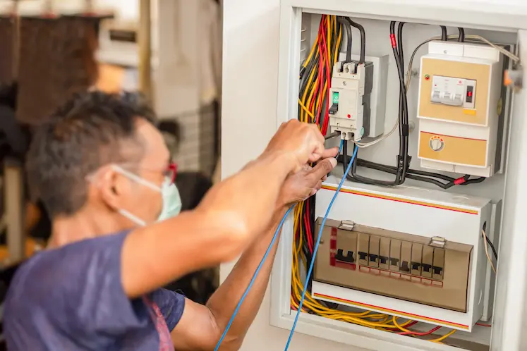Local electrician working on wiring at a West Midlands property