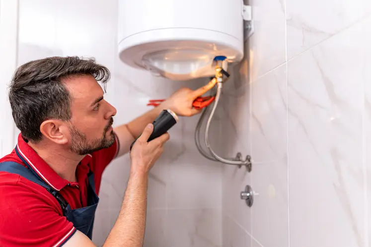 Local plumber repairing a water heater at an East Midlands property
